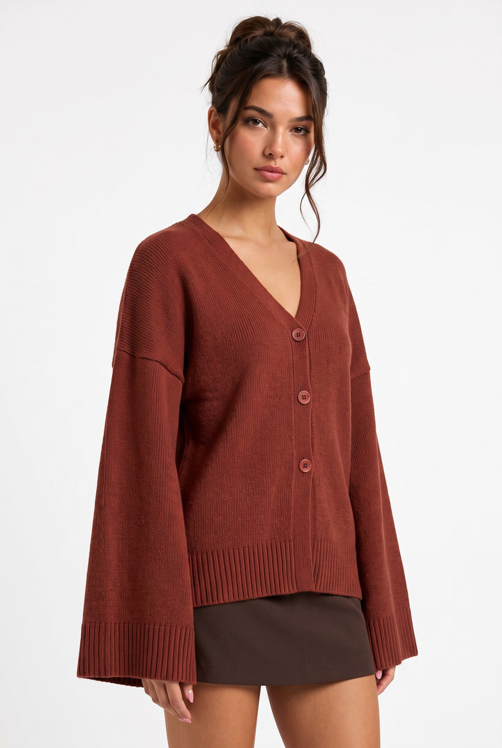 lily Averlyn brick red knit cardigan with V-neck, button front, and wide sleeves worn by a model