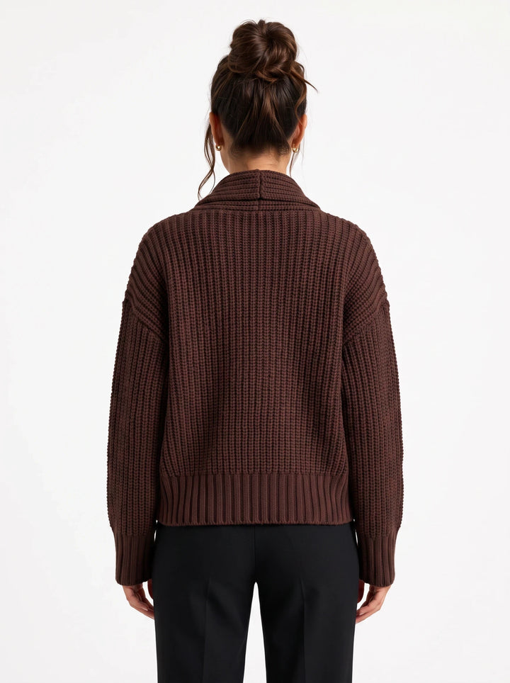Back view of a lily brown chunky ribbed wool-blend cardigan with a structured collar worn over black trousers
