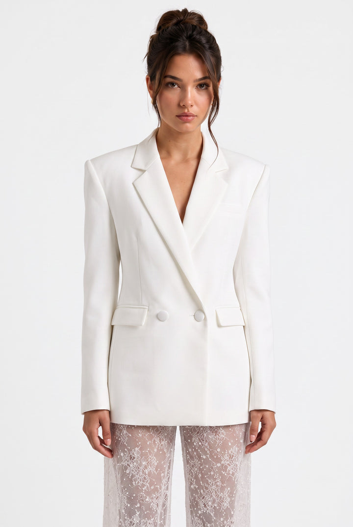 lily ivory double-breasted tailored blazer paired with high-waisted sheer lace trousers on a model