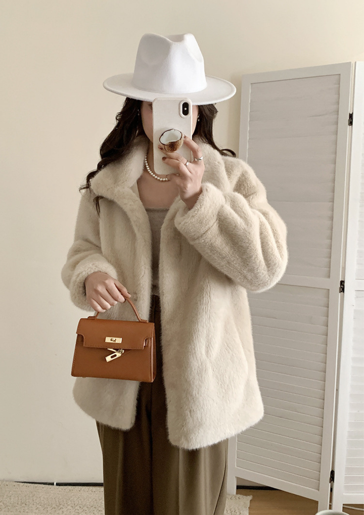 lily Mila plush mink fur coat in cream with a stand collar, worn with a white fedora and brown leather handbag