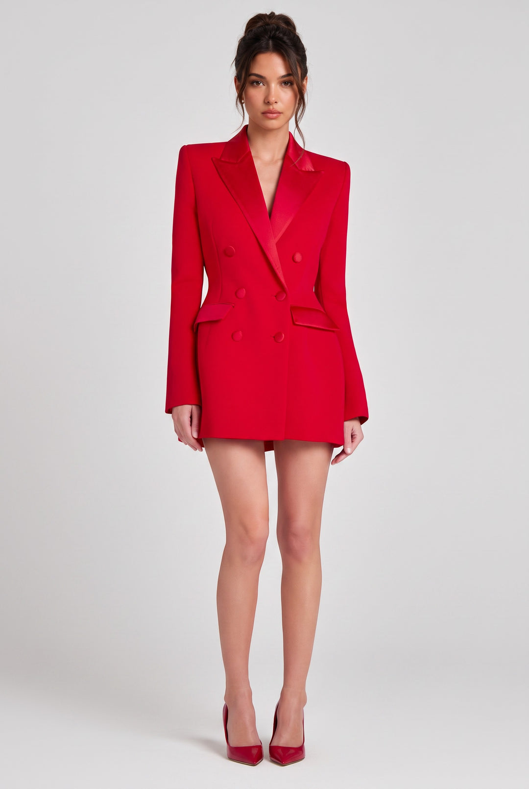 lily model wearing a scarlet red double-breasted blazer dress with satin peak lapels and structured shoulders